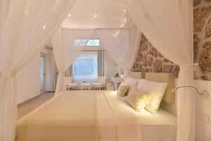 a bedroom with a canopy bed with white curtains at Suite La Mer in Kalkan +35 photos