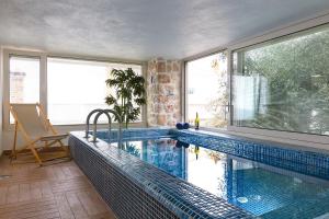 a swimming pool in a room with a large window at Suite La Mer in Kalkan