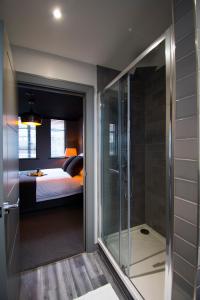 a bedroom with a bed and a glass shower at Green Ginger House in Hull