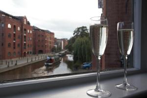 two glasses of champagne sitting on a window sill at Canal House in Chester