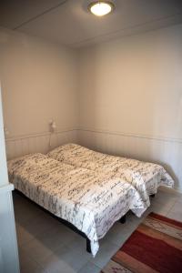 a bedroom with a bed with a white comforter at Aparthotel YlläStar in Äkäslompolo