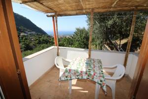a table and chairs on the balcony of a house at B&B Casa Rosola in Colli di Fontanelle
