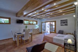 a bedroom with a bed and a table and a desk at Apartments Stipe in Lukovo