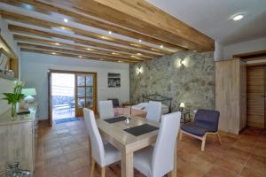 a kitchen and dining room with a table and chairs at Apartments Stipe in Lukovo