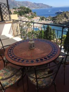 a table that has a table cloth on top of it at ToviMar Apartments in Taormina