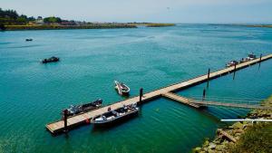 a dock with boats on a large body of water at Jot's Resort in Gold Beach