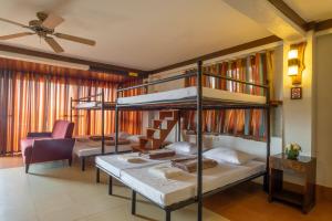 a bedroom with two bunk beds and a couch at West 35 Eco Mountain Resort in Balamban
