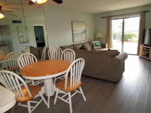 a living room with a table and chairs and a couch at St. Augustine Ocean & Racquet Resort in St. Augustine