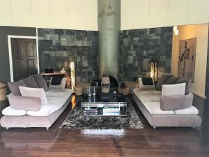 a living room with two couches and a coffee table at Mesilau Mountain Retreats in Kundasang