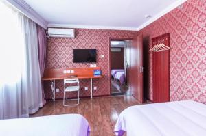 
a hotel room with a television and a bed at Beijing Aulympic Airport Hotel in Shunyi

