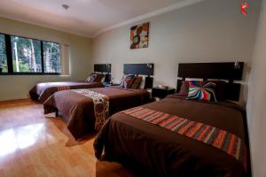 En eller flere senge i et værelse på Hostal Kolibri B&B