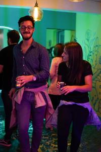 a man and a woman standing at a party at Nativus Art Hostel in San José