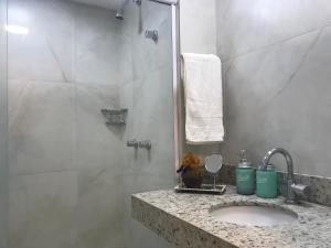 a bathroom with a sink and a shower at Pipa Flat Top Ocean Residence in Pipa +15 photos