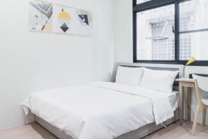 Postel nebo postele na pokoji v ubytování Boléro Homestay I 鄰近花園夜市