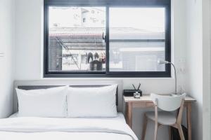 Postel nebo postele na pokoji v ubytování Boléro Homestay I 鄰近花園夜市