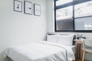 Postel nebo postele na pokoji v ubytování Boléro Homestay I 鄰近花園夜市