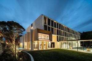 a large building with a lawn in front of it at Mercure Sydney Rouse Hill in Kellyville