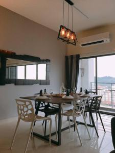 a dining room with a table and chairs with a view at Puchong Setiawalk Residence By Iconique Espace in Puchong