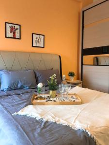 a tray on a bed with glasses and plants on it at Puchong Setiawalk Residence By Iconique Espace in Puchong +24 photos