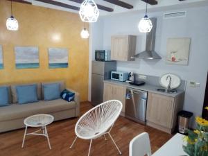 a living room with a couch and a kitchen at Espai One Valencia in Valencia