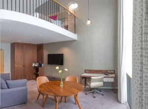 a living room with a table and a couch at Best Western Atlantic Hotel in Chelmsford +55 photos