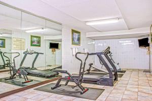 a gym with three exercise bikes in a room at Baymont by Wyndham McDonough in McDonough