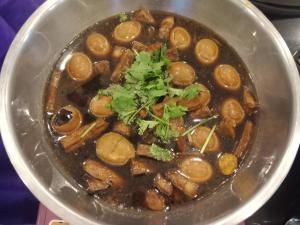 a bowl of stew with beans and cilantro in it at NP Hotel in Buriram