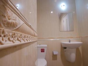 uma casa de banho com um lavatório, um WC e um espelho. em Nirvana@Phala em Ban Chang
