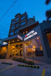 a hotel camillin building with a sign on it at Hotel Carmelita in Tuguegarao City