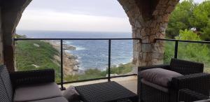 a balcony with chairs and a view of the ocean at Castelia in Lumio