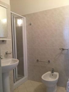 a bathroom with a toilet and a sink at Case Vacanze Panarea by CivicoVentiquattro in Cava dʼAliga