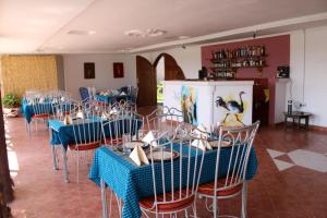 a dining room with blue tables and chairs at Dan Stam Hotel in Arusha