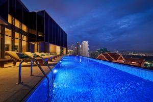 a swimming pool on top of a building with a city skyline at Grand Mercure Ahmedabad GIFT City - An Accor Hotels Brand in Gandhinagar