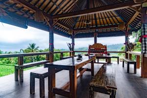 
a patio area with a table and chairs at Pondok Nyoman in Bedugul
