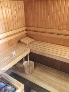 a sauna with a bench and a bucket in it at Suite & Wellness in Breskens