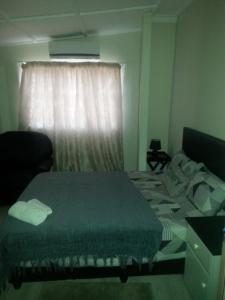 a bedroom with a bed and a window at Zanevovo in Scottburgh
