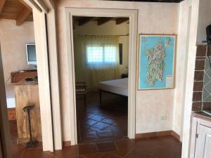 an open door to a bedroom with a bed in a room at Sa Codina in Marina di Portisco