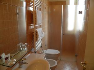 a bathroom with a toilet and a sink and a shower at Hotel Cappelli in Montecatini Terme