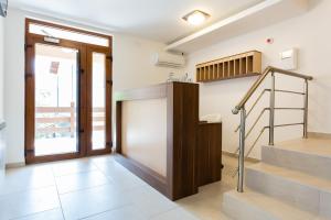 a room with stairs and a door and a stair case at Vila Almax in Soko Banja