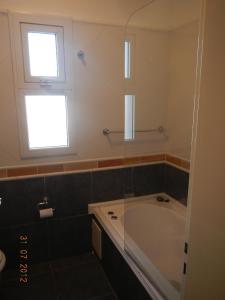 a bathroom with a tub and a window at Duplex Barrancas in Puerto Madryn +11 photos