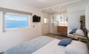 a bedroom with a bed and a sink and a window at Holiday house Karla in Vela Luka