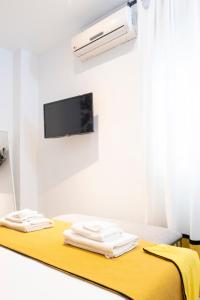 セビリアにあるAD3A Apartment Antonia Diaz st 250mts de Catedralのベッド1台、壁にテレビが備わる客室です。