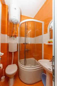 a bathroom with a shower and a toilet and a sink at Apartments Sergej in Sutomore +48 photos