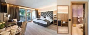 Postel nebo postele na pokoji v ubytování Wellness Hotel Gran Risa***S
