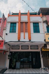 a white building with orange shutters on it at Kooning in George Town