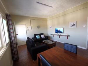 a living room with a couch and a table at TD Guest House 1 in Chimoio