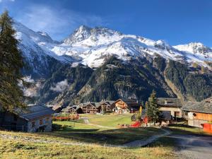 a village with a mountain in the background at Black Diamond Sainte Foy Chalets in Sainte-Foy-Tarentaise