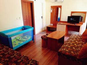 a room with a bed and a desk with a computer at Hotel Valena in Kiten
