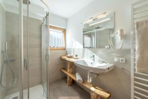 a bathroom with a sink and a shower at Ferienbauernhof Wieserhof in Völs am Schlern