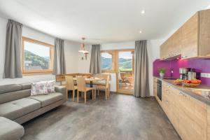 a kitchen and living room with a couch and a table at Ferienbauernhof Wieserhof in Völs am Schlern